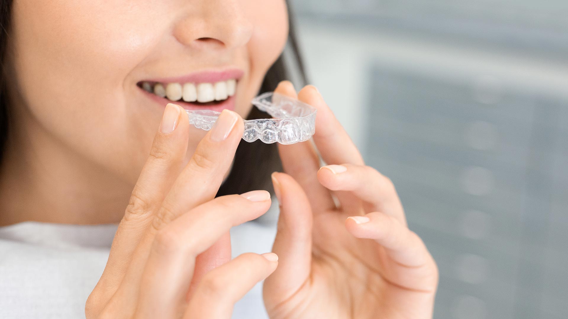 woman using invisalign to correct overbite